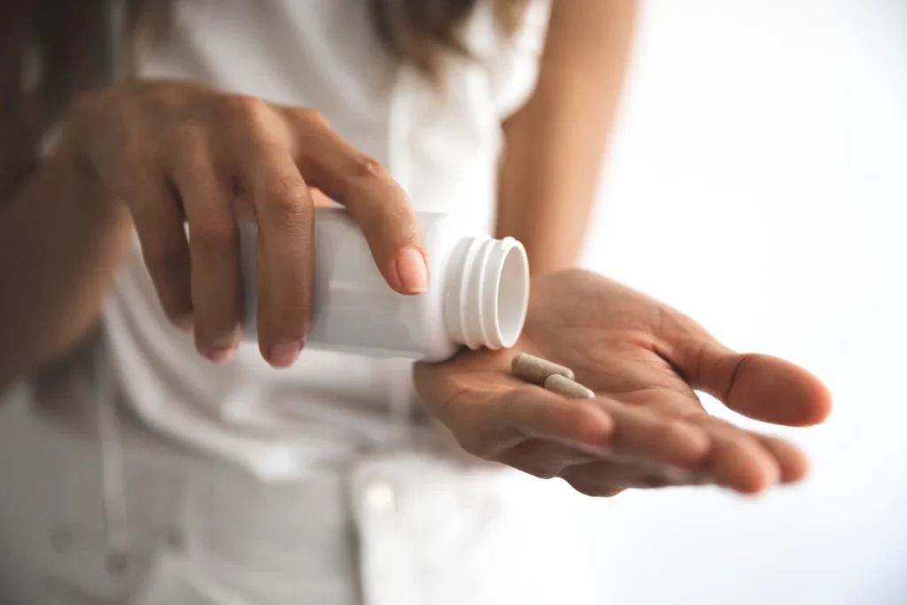 Woman taking health supplements. 