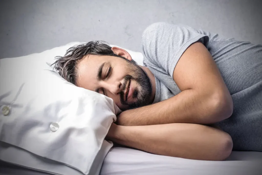 young men sleeping on a bed