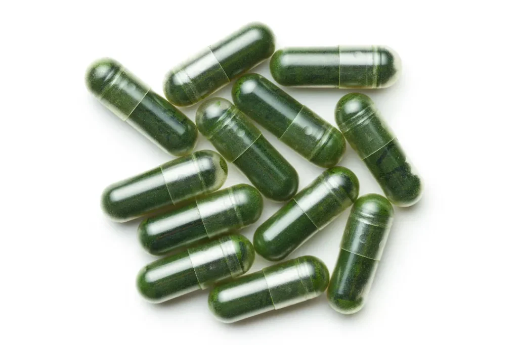 Chlorella pills on white background