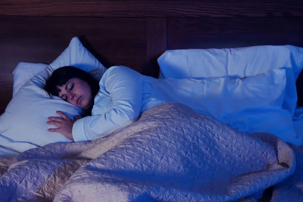 A lady sleeping on bed. 