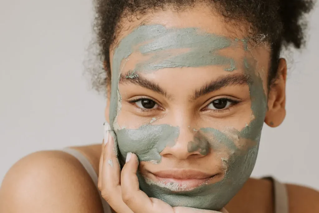 A girl applied a mud mask on face. 