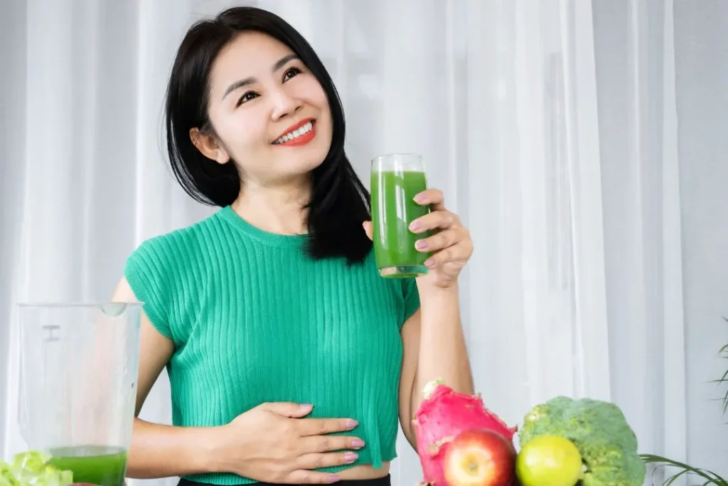 A lady drinking juice. 