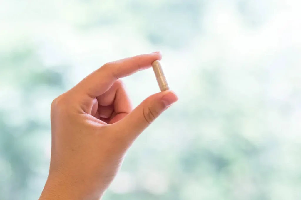 women holding pill in his hand