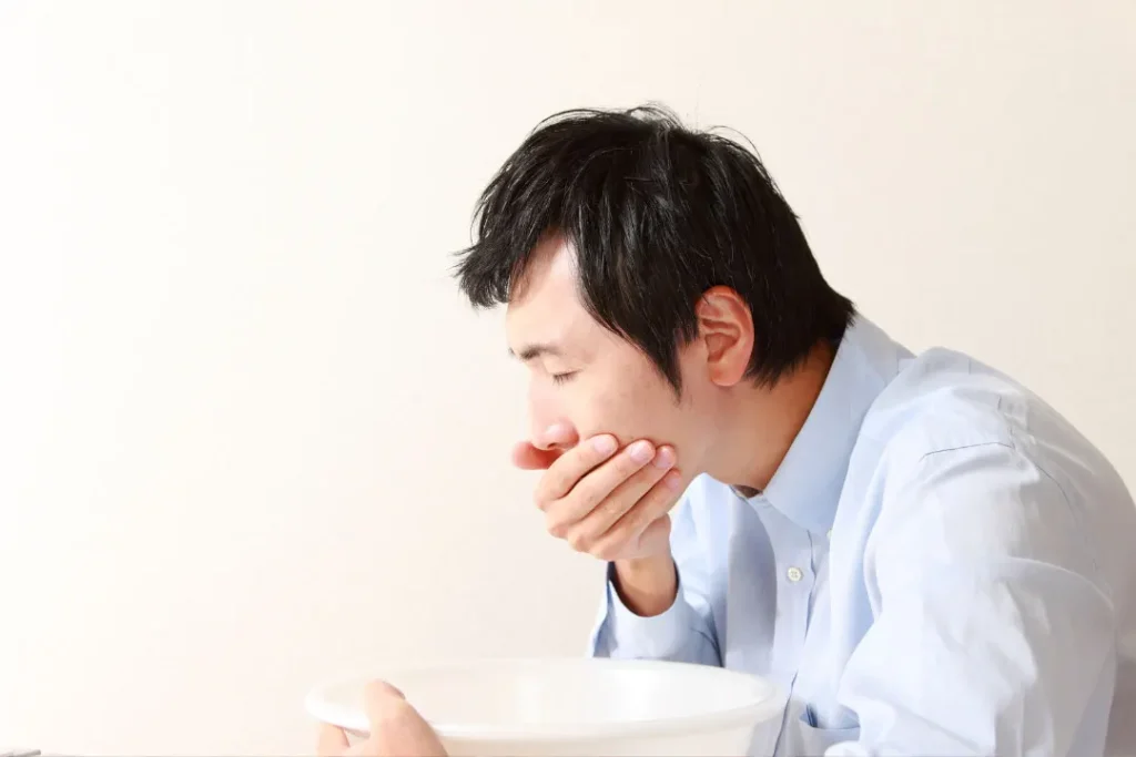 A young man having vomit. 