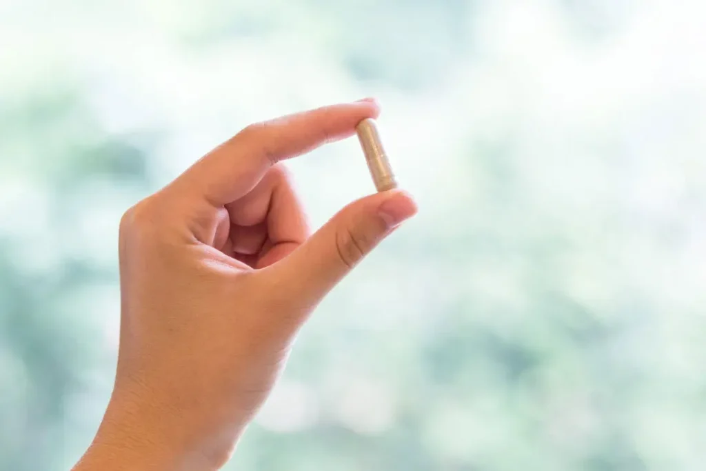 women holding pill in his hand