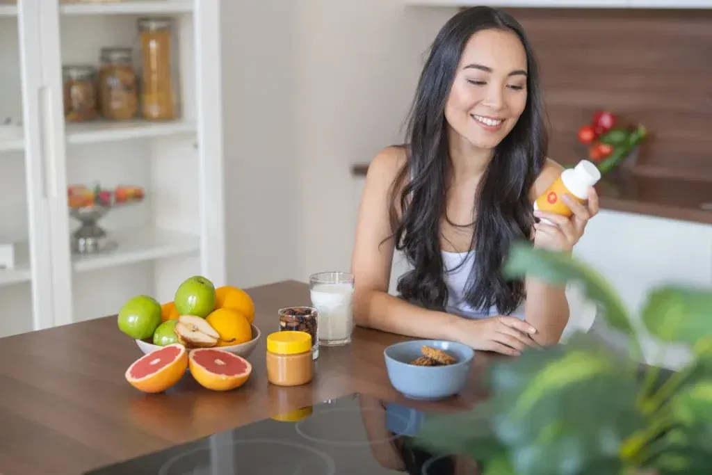 Woman holding Brain supplements for brain fog after covid