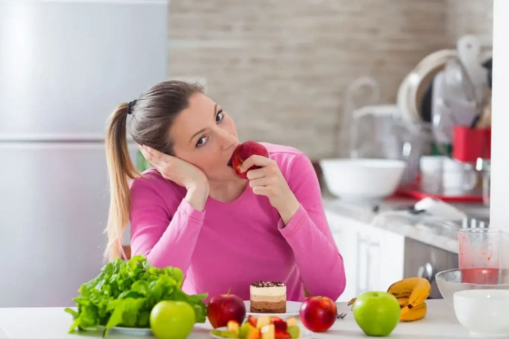 A lady is eating an apple. 