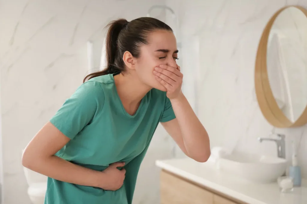 Young girl having vomit. 