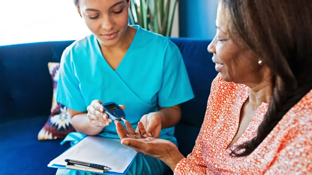 Doctor checking the blood sugar level of patient. 