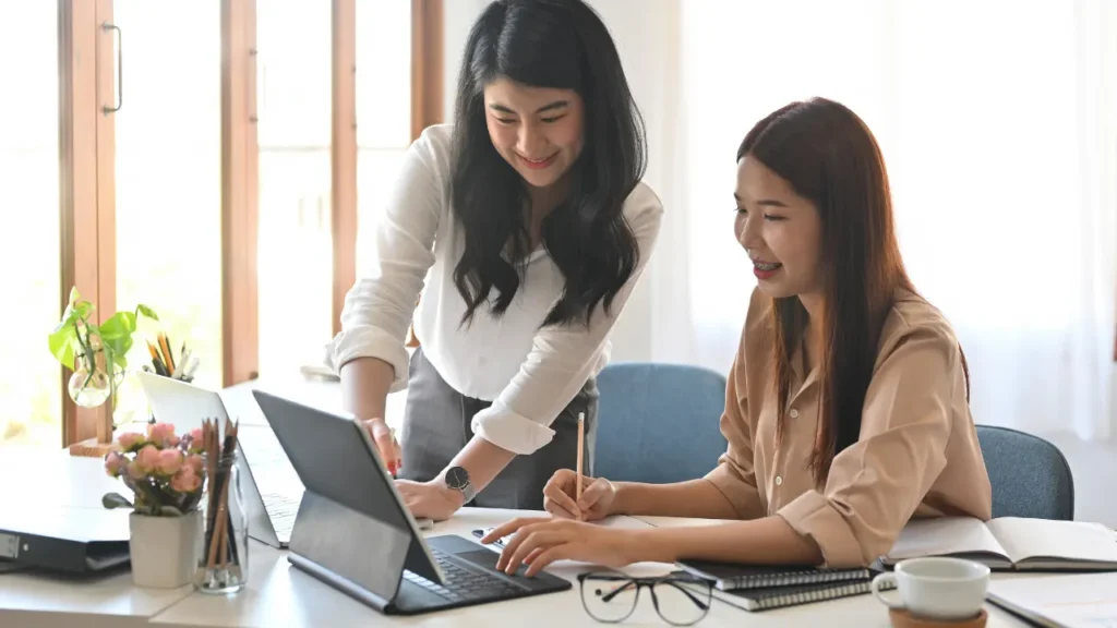 Ladies are working on laptop.