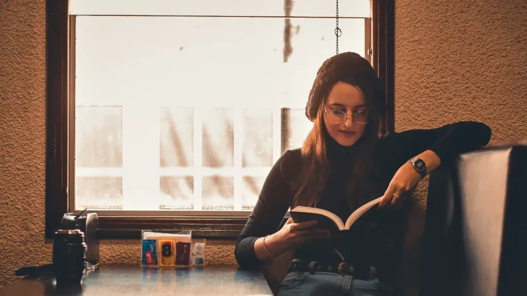 Lady is reading a book. 