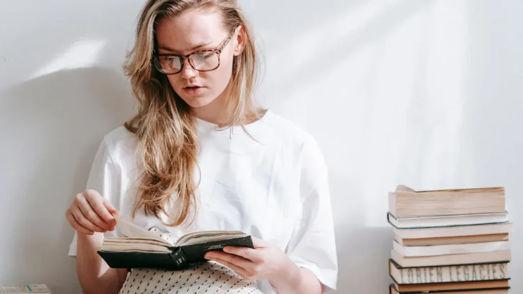 Lady is reading a book. 