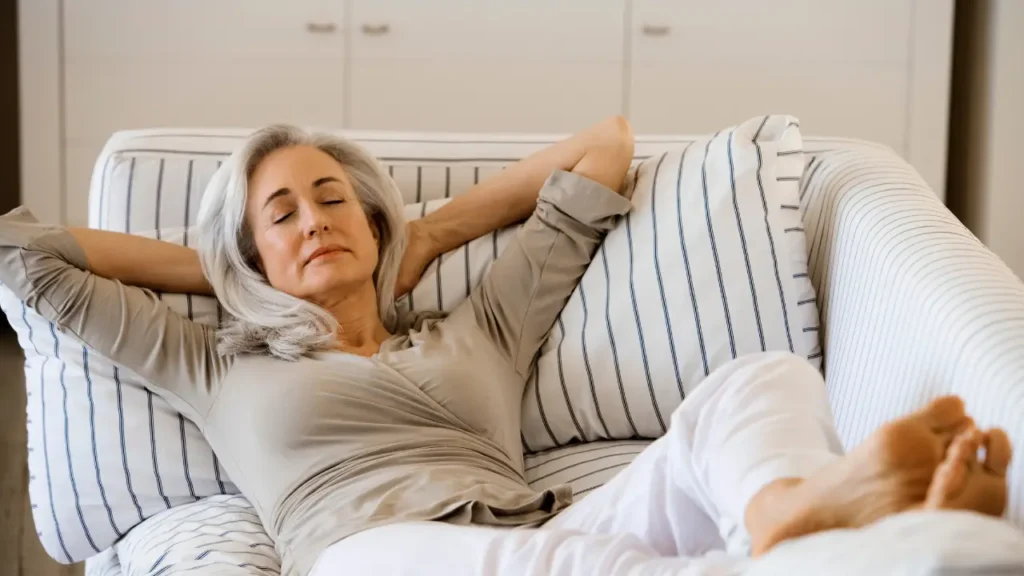 Aged Woman Relaxing while sleeping on a sofa